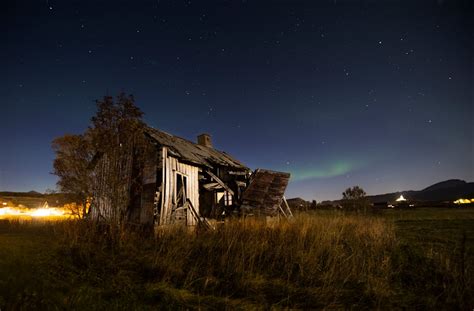 Abandoned wooden barn on grassy terrain against starry night sky · Free ...