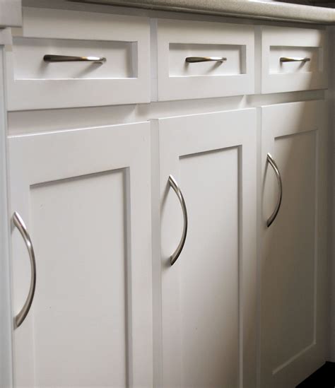 Clean, simple kitchen cabinet doors and drawer fronts with bow pulls ...