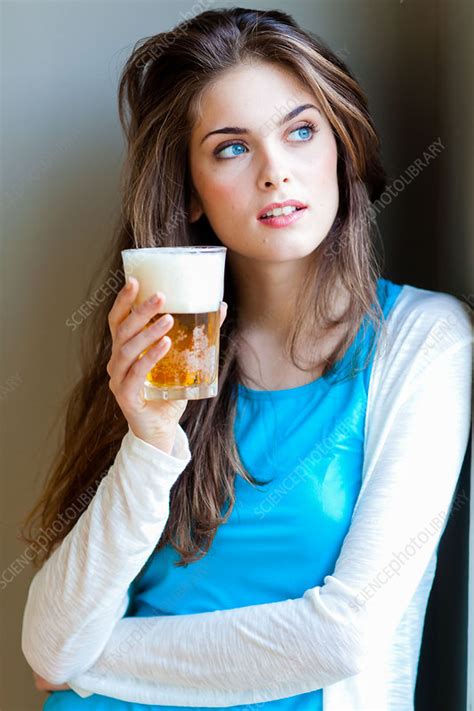 Woman drinking beer - Stock Image - C032/8718 - Science Photo Library