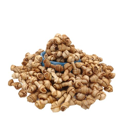 a pile of wood beads sitting next to a blue bowl