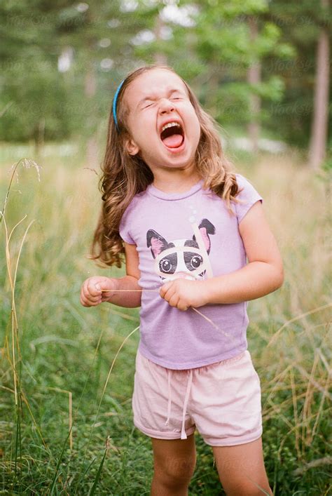 "Cute Young Girl Making A Funny Face In A Field" by Stocksy Contributor ...