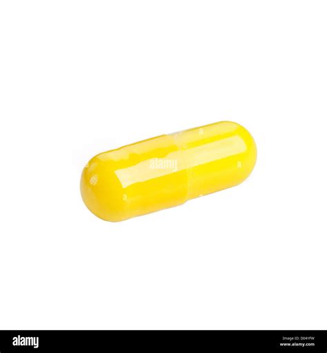 Yellow pill capsule closeup on white Stock Photo - Alamy