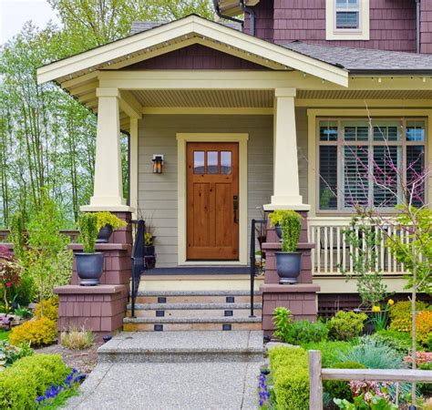 a small house with flowers and plants in the front yard