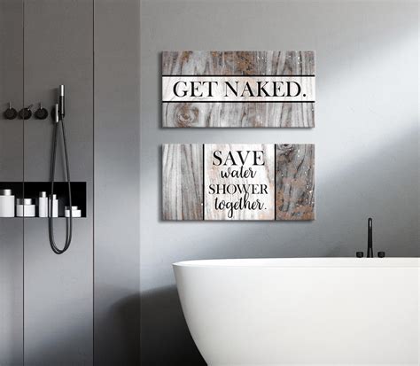 a bathroom with a tub, sink and two wooden signs on the wall above it