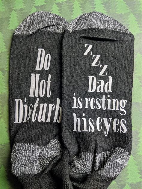 two socks with words written on them sitting next to each other in ...