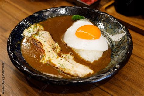 Japanese curry rice with fried egg and grilled pork belly. Stock Photo ...