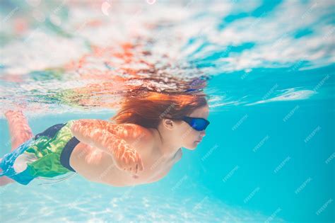 Premium Photo | Kid swimming in pool underwater child boy swim ...