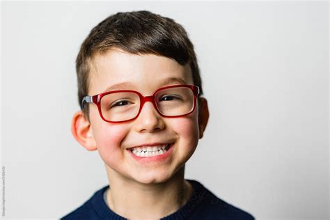 "Studio Portrait Of A Smiling Child With Glasses" by Stocksy ...