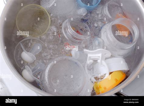 Sterilizing baby bottles in boiling water Stock Photo - Alamy