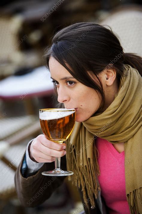 Woman drinking beer - Stock Image - C031/6172 - Science Photo Library