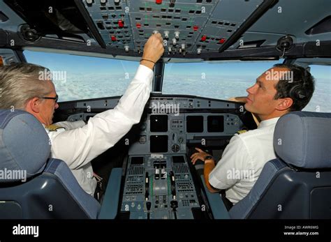 Pilots in the cockpit of an Airbus 321, in flight Stock Photo - Alamy