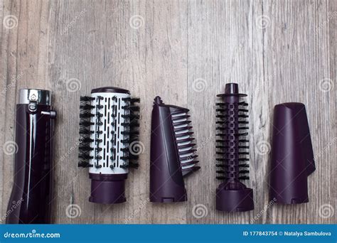 Set of Hair Dryer Attachments on a Wooden Background. Curling Iron ...