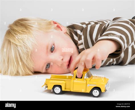 Little boy playing with yellow truck Stock Photo - Alamy