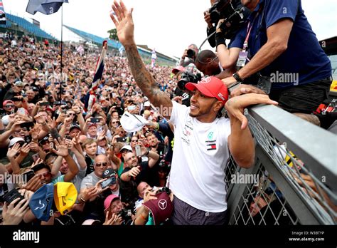 Mercedes' Lewis Hamilton celebrates with fans after winning the British ...