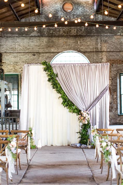 Bohemian Altar with Curtains and Greenery in Industrial Venue