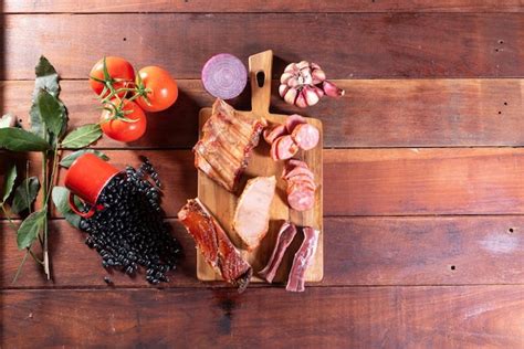 Premium Photo | A wooden table with a cutting board with meat and ...