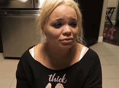 a woman is making a face while sitting on the floor in front of an oven