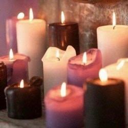 many lit candles are arranged on a table