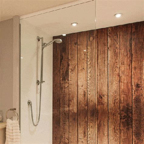 a bathroom with wood paneling on the wall and shower head mounted to ...