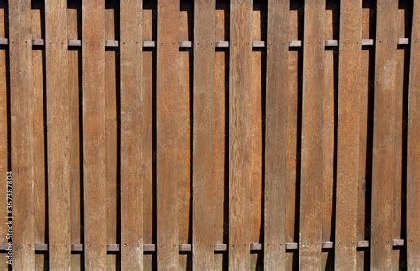 Wooden fence with vertical slats. Natural brown wood planks, wood ...