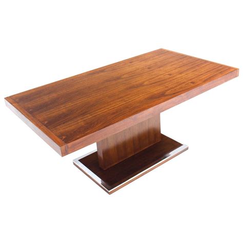 a wooden table with metal legs and a square top on an isolated white ...