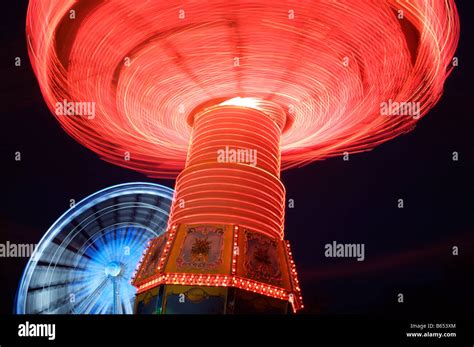 A Carousel and Ferris Wheel at Winter Wonderland, London Stock Photo ...