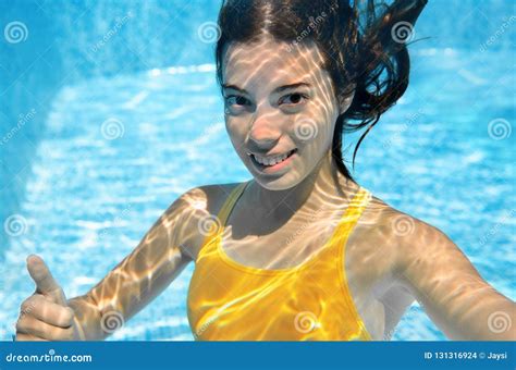 Girl Swims in Swimming Pool Underwater, Happy Active Teenager Dives and ...