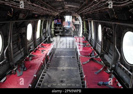 A CH-46 Sea Knight helicopter hovers over the flight deck of the ...