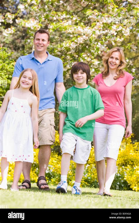 Family walking outdoors smiling Stock Photo - Alamy