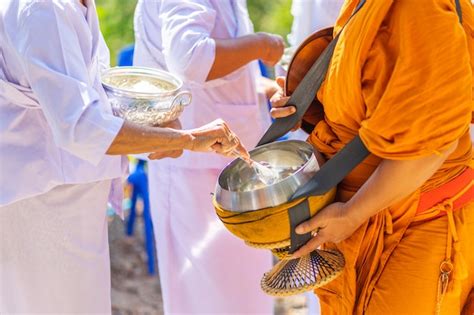 Premium Photo | The monks of the buddhist sangha(give alms to a ...