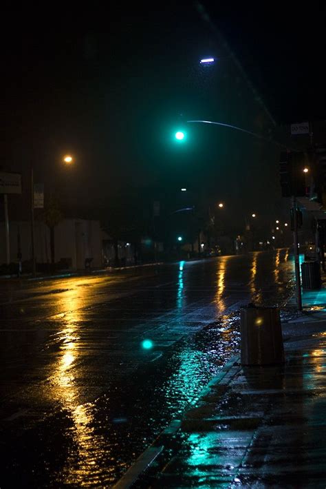 a wet street at night with the lights on