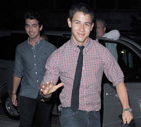 Joe and Nick arrive at hotel with mystery brunette (pictured in one ...