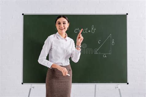 Smiling Teacher Pointing with Finger Near Stock Photo - Image of ...