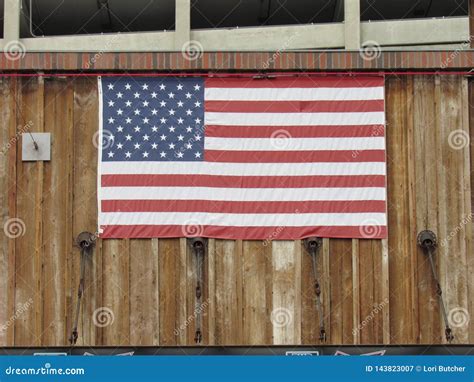 American Flag Hanging on Building Exterior Stock Image - Image of ...