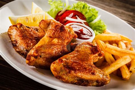 Grilled Chicken Wings, Chips and Vegetables Stock Image - Image of ...