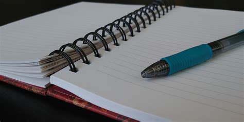 Open Notebook With Blue Pen Free Stock Photo - Public Domain Pictures