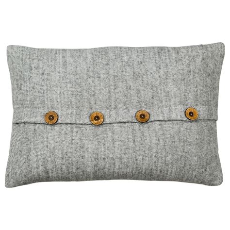 a gray pillow with three buttons on the front and two in the back ...