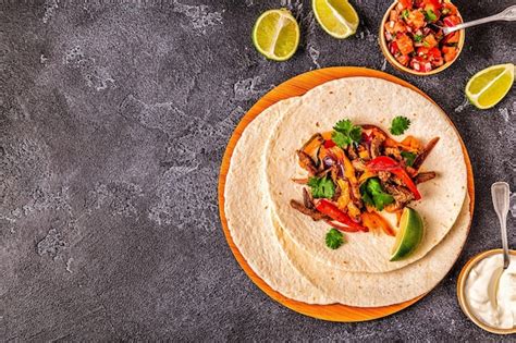 Premium Photo | Fajitas with colored pepper and onions served with ...