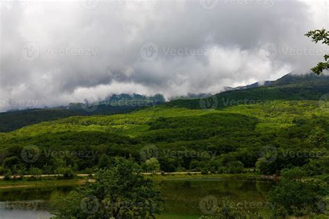 Mountain lake with mountain views and clouds. 9502475 Stock Photo at ...