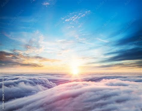 Beautiful sunset sky above clouds Stock Photo | Adobe Stock