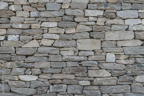 Stone wall texture background - grey stone siding with different sized ...