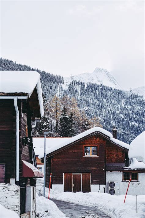 Snow Covered Houses Near the Mountain · Free Stock Photo