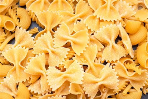 Premium Photo | Italian pasta, shapes of dry italian pasta as background