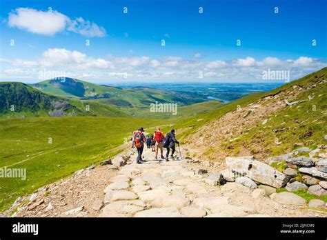 SNOWDON, WALES - JULY 09, 2022: Hikers walk dawn from Mount Snowdon ...