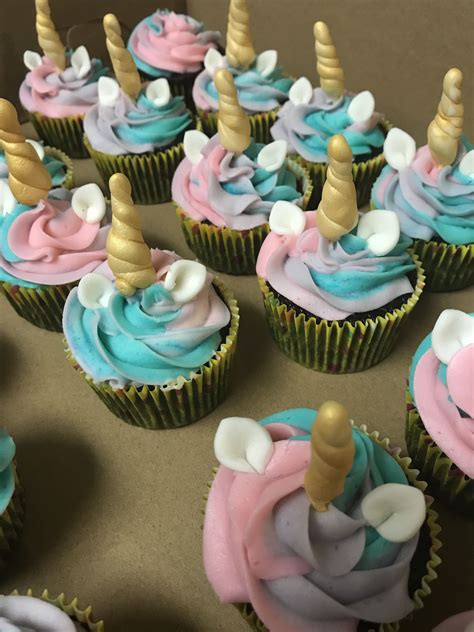 cupcakes decorated with pink, blue and gold icing