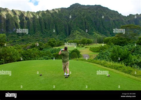 Golfer driving on beautiful 5th hole on Ko'olau Golf Course in Stock ...