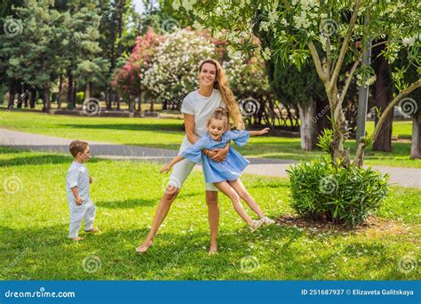 Happy Family Outdoors on the Grass in a Park, Smiling Faces, Having Fun ...