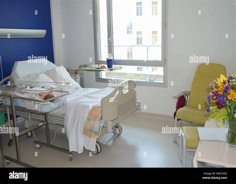 Empty hospital room with a bed for patient and newborn baby near the ...