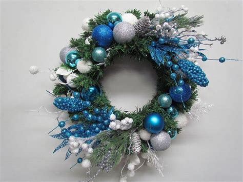 a christmas wreath with blue and silver ornaments