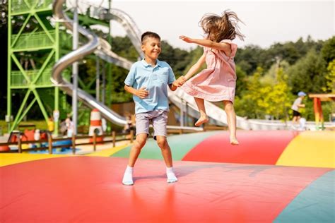 Premium Photo | Kids jumping on inflatable trampoline in amusement park